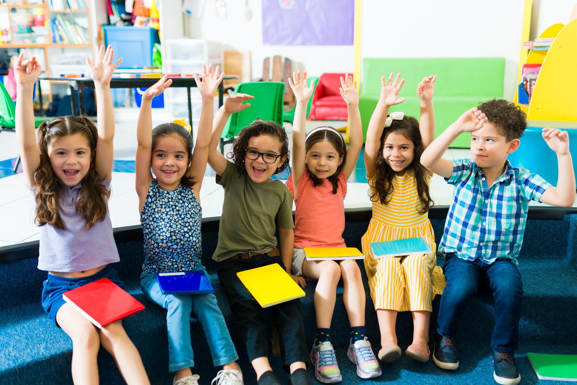 Excited diverse kids learning and celebrating at preschool